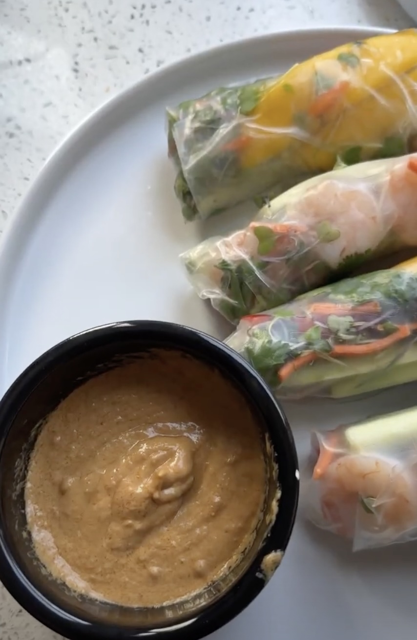 shrimp summer rolls with peanut sauce on white plate